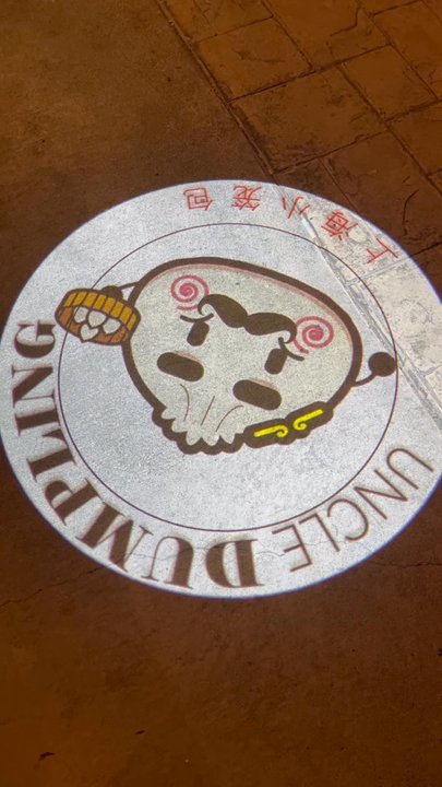Uncle Dumpling - A light that shows the "Uncle Dumpling" logo. - Noodles Near Me - Roseville, California