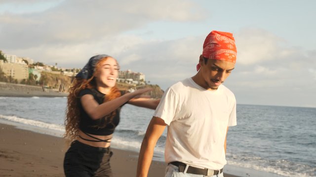 Woman jumps on man's back