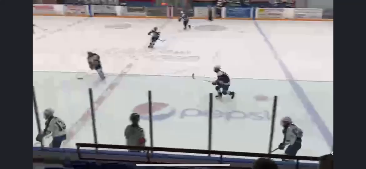Ross reverse hits player while skating with the puck into the zone