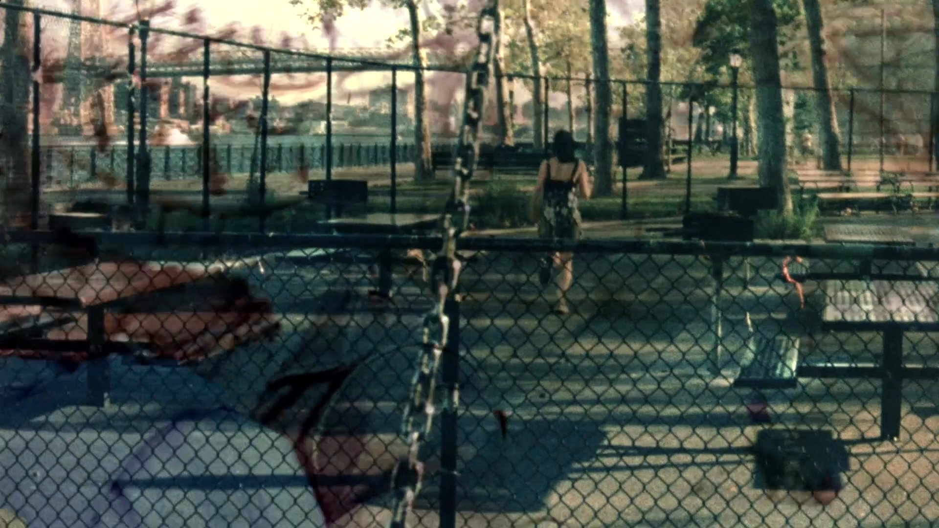 A family portrait transitions into solitary scenes of an individual navigating a playground and a park, evoking themes of past and present. The imagery shifts from a warm, nostalgic group photograph to a quiet, contemplative exploration of an urban landscape.