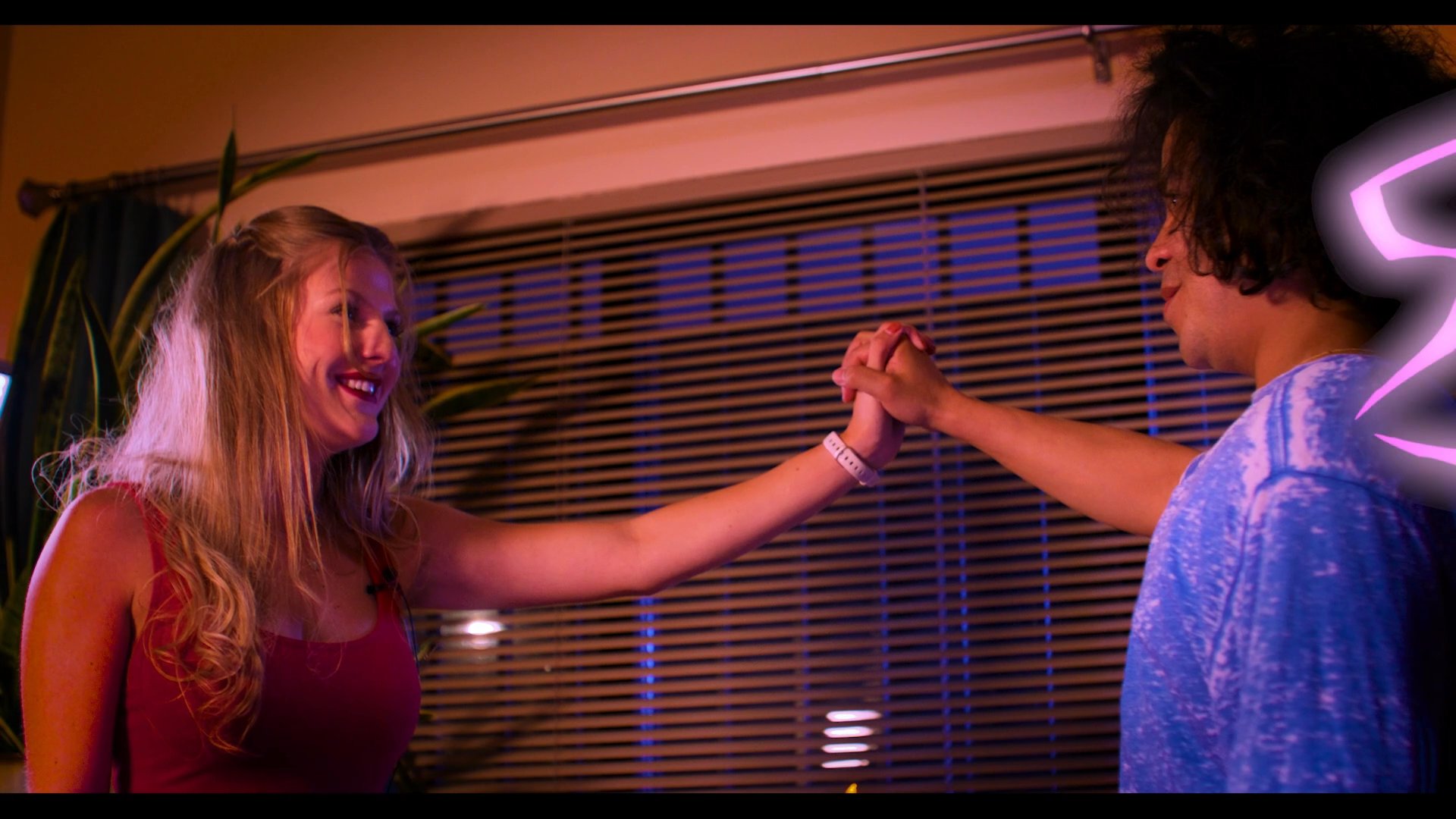 A film production team captures a mystical psychic reading sequence involving a supernatural visual effect connecting two individuals. The scene transitions from a staged filming environment to a dramatized encounter between a medium and her client.