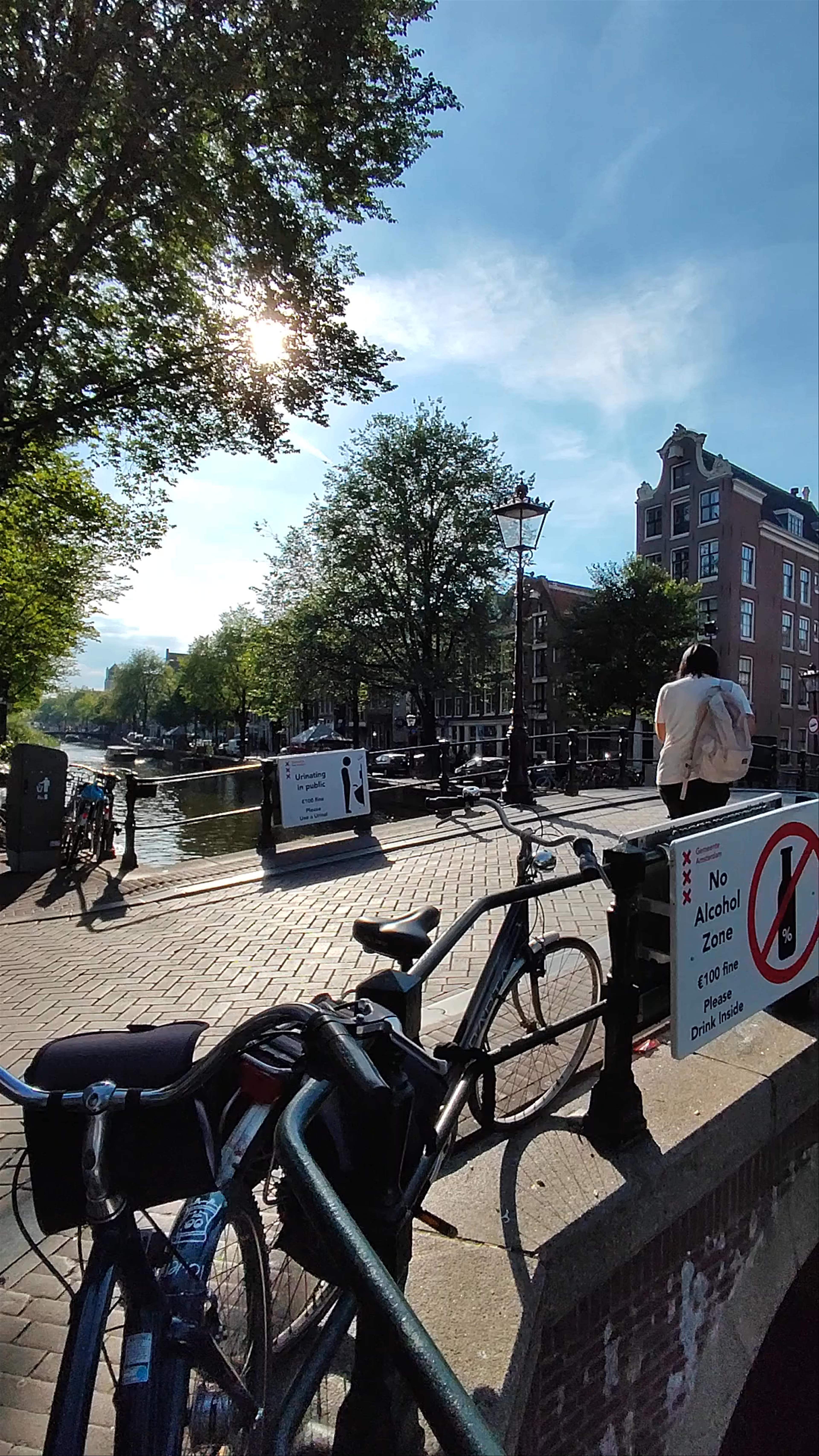 Oudekerksbrug: Sunlit Canal Bridge in Amsterdam