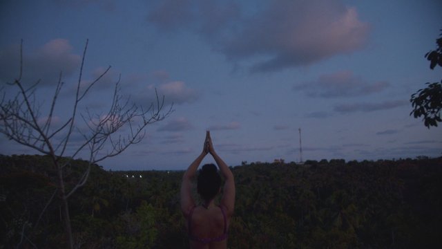 Woman doing yoga in the evening
