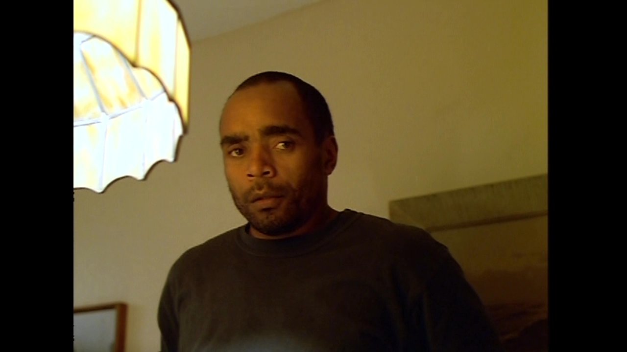 Three individuals engage in a tense and focused dinner conversation at a residential dining table. The scene highlights subtle emotional exchanges and non-verbal cues during the meal.