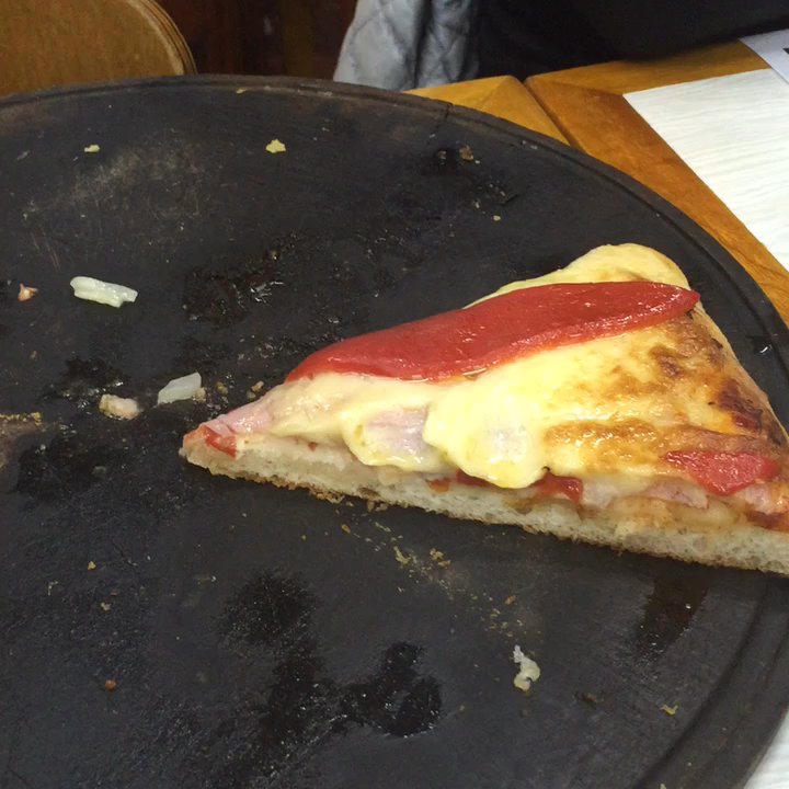 El Cuartito - What's left of our delicious pizza and quick view of the restaurant. It's filled with photographs signed by famous individuals. - Pizza Near Me - Buenos Aires, C