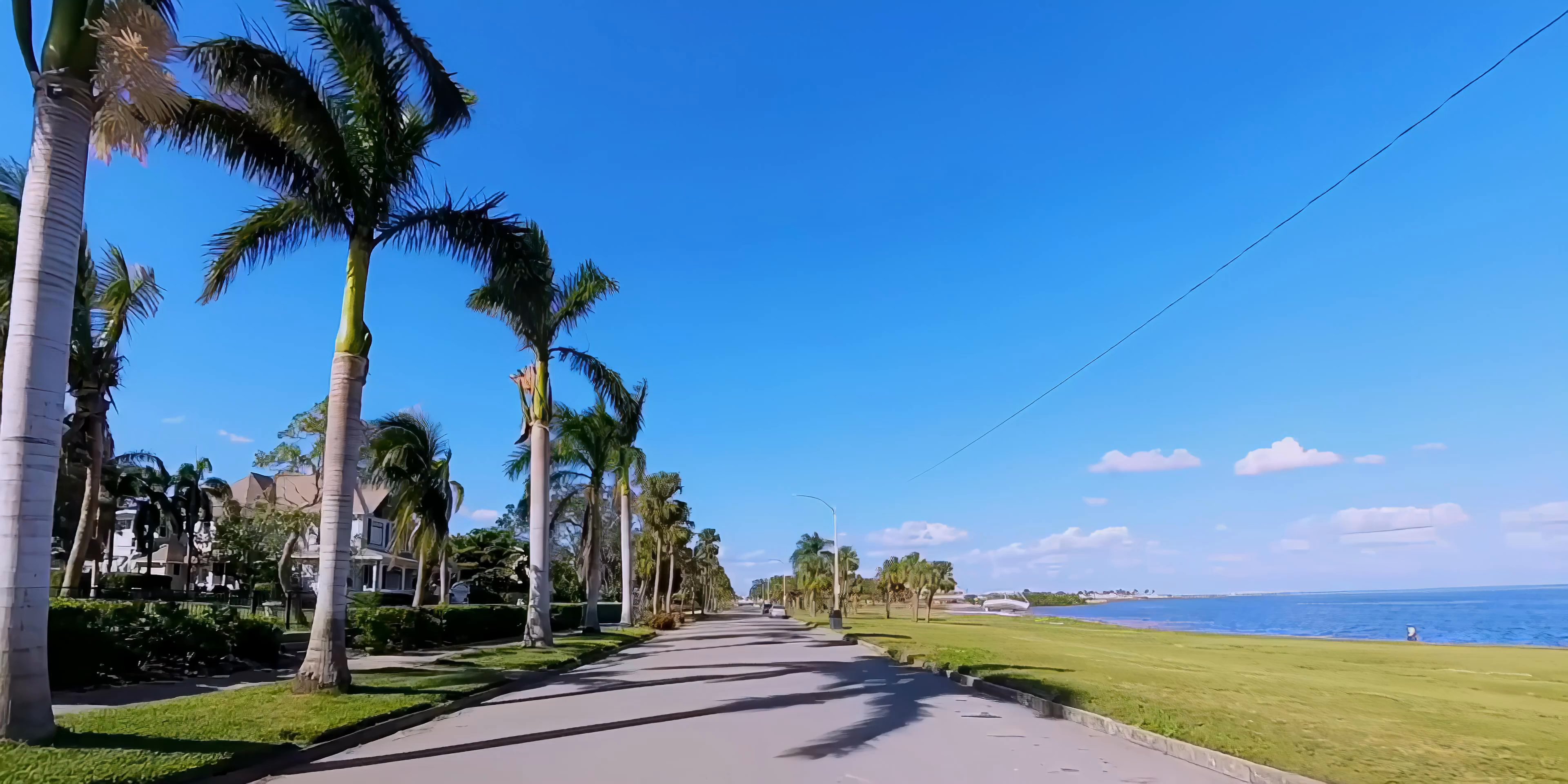 Aerial shots of the St. Petersburg coastline and urban skyline transition into a perspective from inside a vehicle driving through city streets.