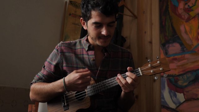 Man playing the ukulele