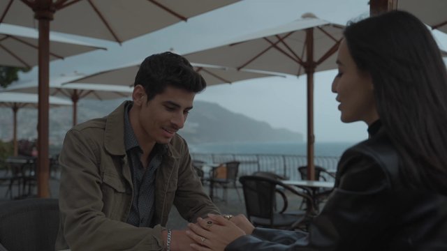 An intimate couple sitting together in a café