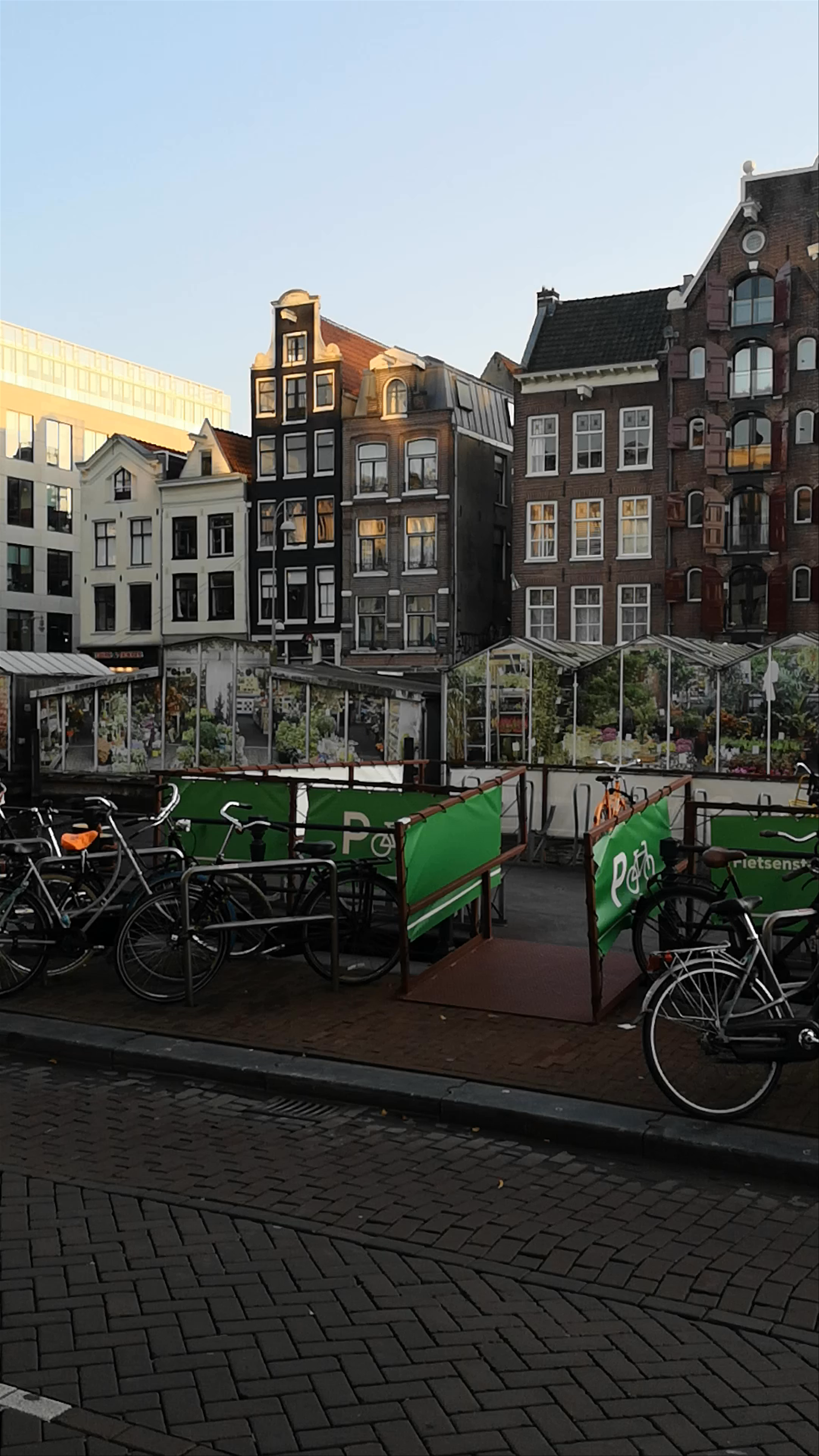 Cycling Through the Historic Heart of Amsterdam at Dusk