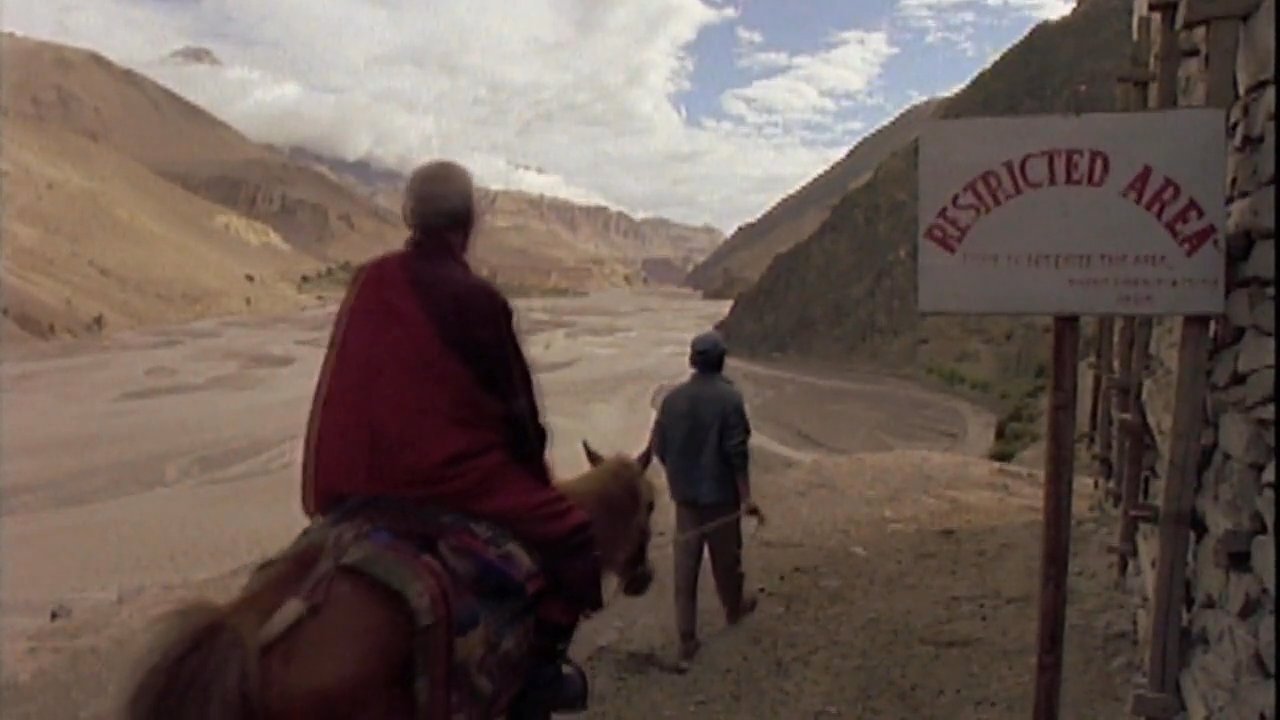 The footage contrasts archival scenes of military conflict and prisoners in Tibet with a modern-day journey by horse past restricted areas and an interview regarding the region's historical situation.