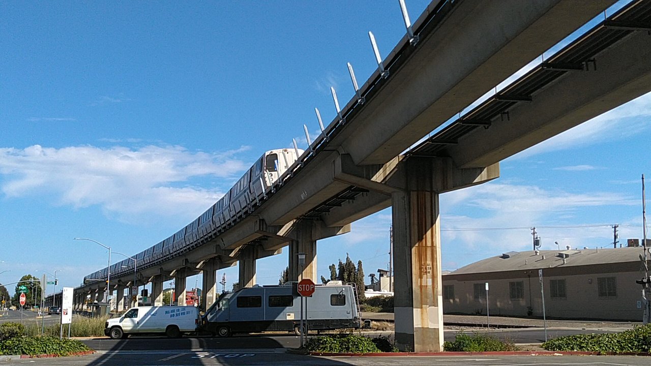 BART - Bay Area Rapid Transit - A BART train is zooming by in the East Bay.  Why can't L.A. and Houston put up simple trestles just like these and get it done? - Public Transportation Near Me