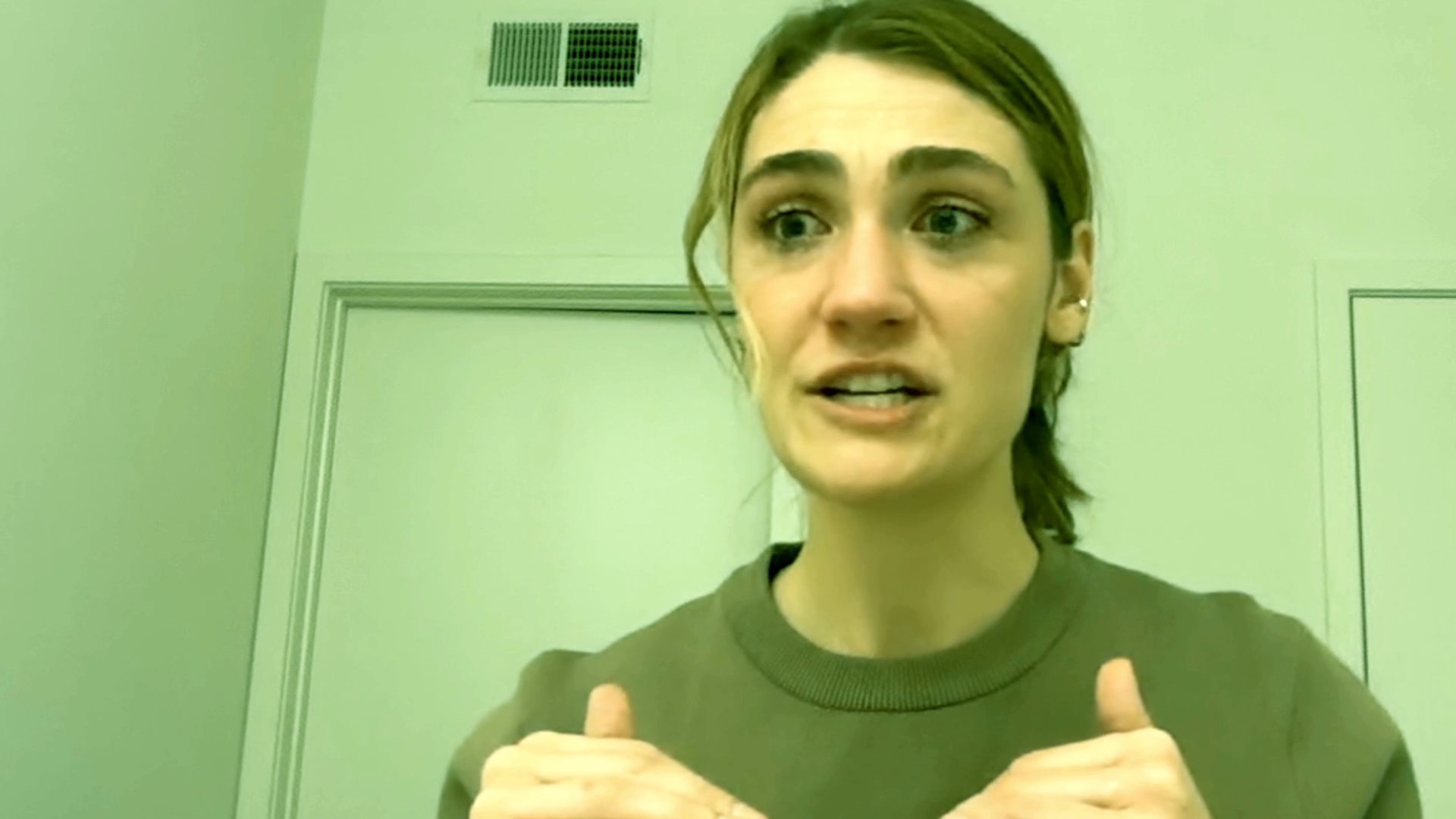 A woman exhibits visible signs of deep distress and emotional turmoil, tears streaming down her face as she appears to recount a painful experience.