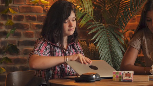 Student opens her laptop to study