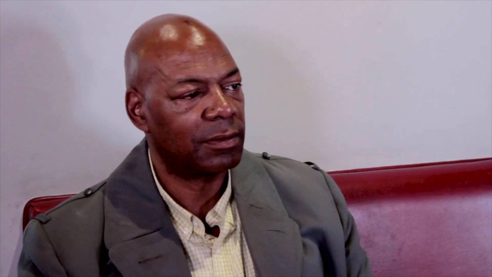 Two individuals engage in a seated interview within a restaurant environment, alternating focus between them as they converse.