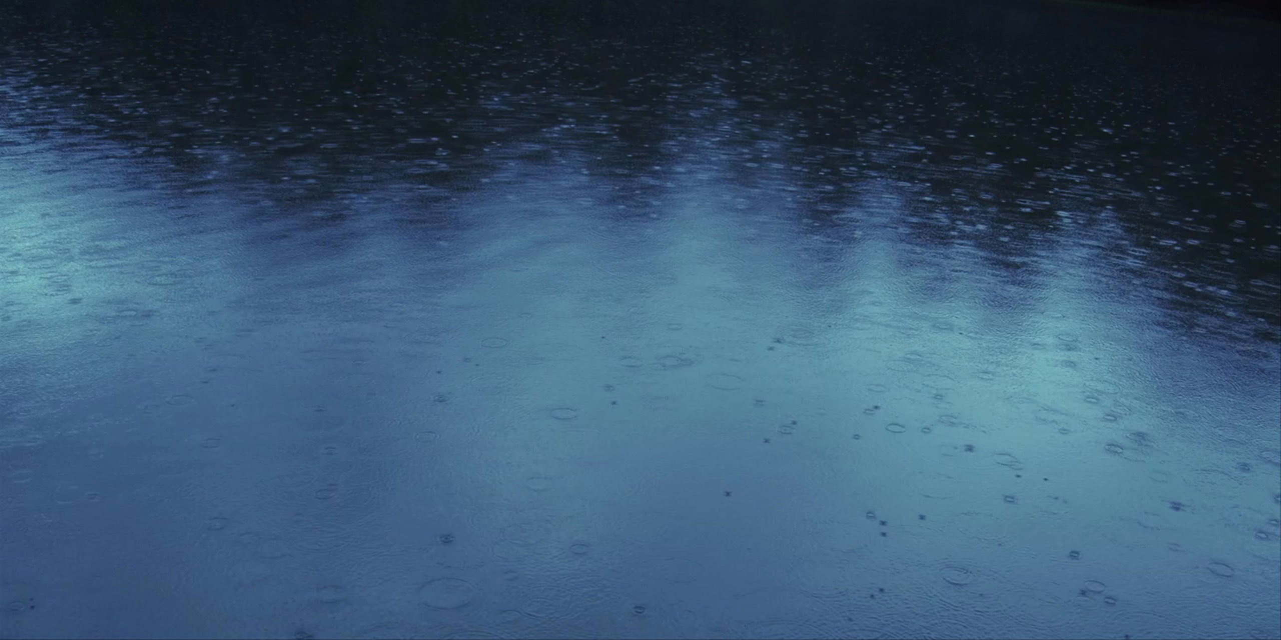 Rain falling on blue lake