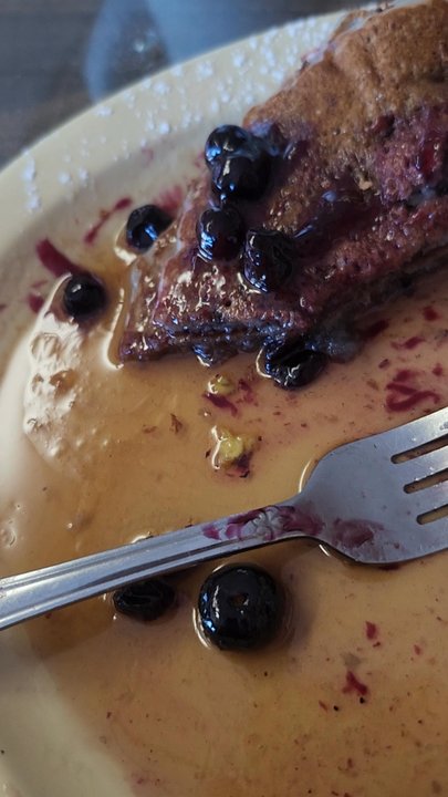 Egg Heaven Cafe - What's left of my blueberry pancakes and you can see how many are still left lots of blueberries - Breakfast & Brunch Near Me - Long Beach, California