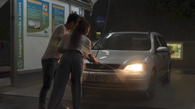 Man and woman washing car together