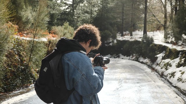Man photographs his friends in the forest
