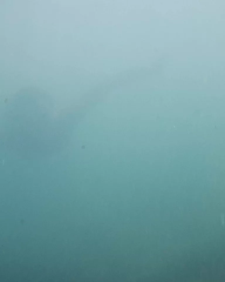 Woman swimming underwater in Hawaiʻi