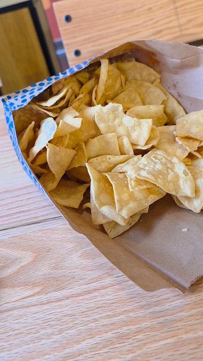 QDOBA Mexican Eats - My Bowl of Brisket and Pork being enhanced with a pouring of Queso. - Mexican Near Me - Roanoke, Virginia