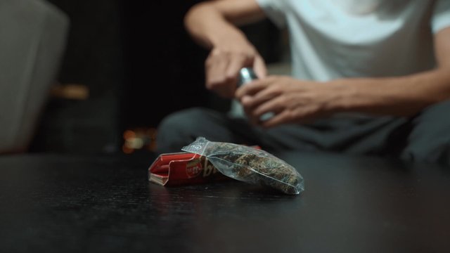 Marijuana buds and cigarette paper on a table