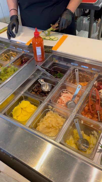 Blk Mkt Eats - Making the burrito - Sushi Bars Near Me - Maplewood, Missouri