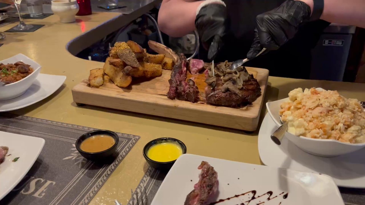 Strip Steakhouse - Requested tomahawk to be sliced since sharing.  Came out and bartender then hacked through the grissly steak with steak knife - Steakhouses Near Me - Avon, Ohio
