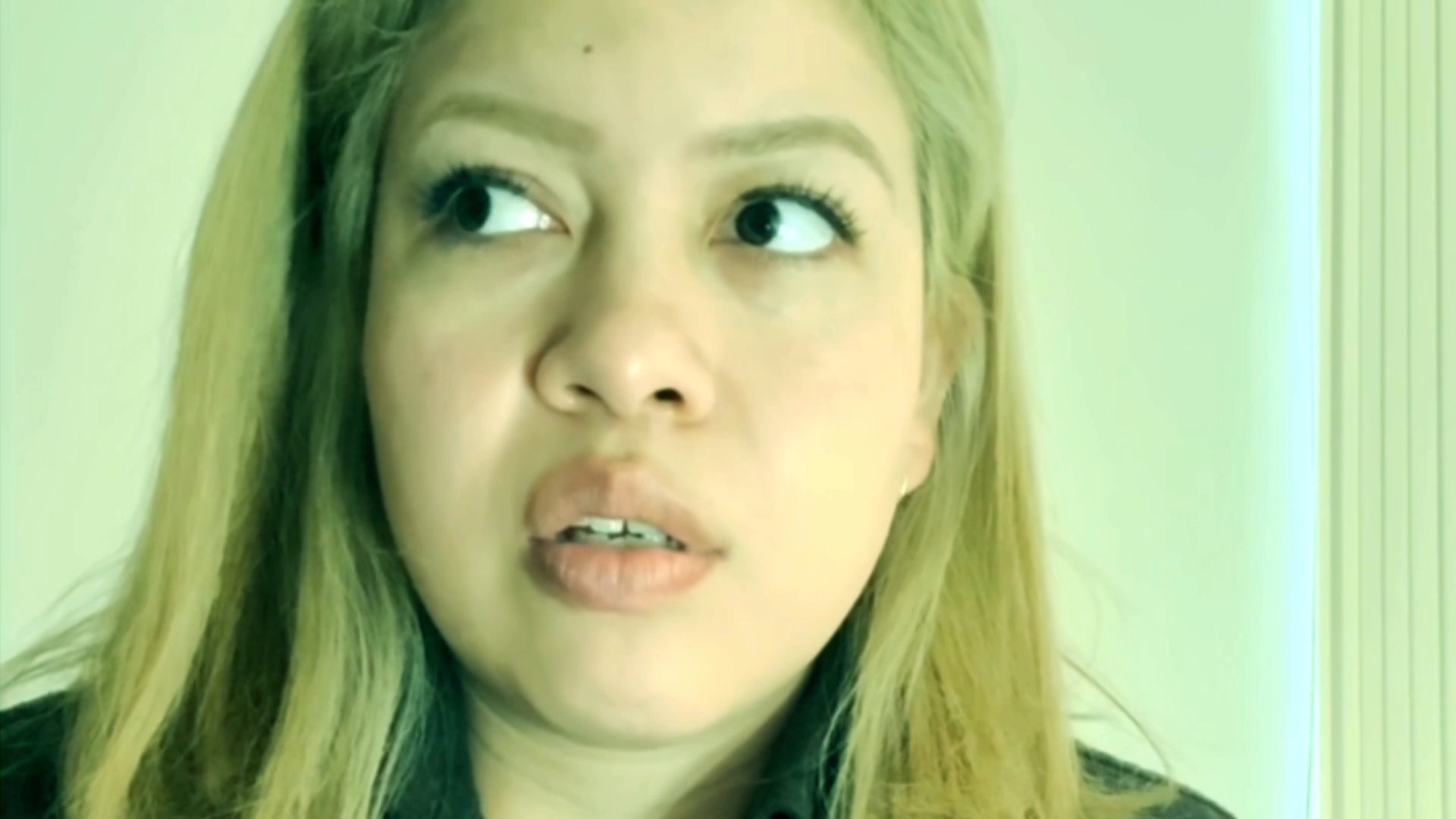 A woman with blonde hair addresses the camera directly, sharing thoughts or a personal narrative in a casual, conversational style.