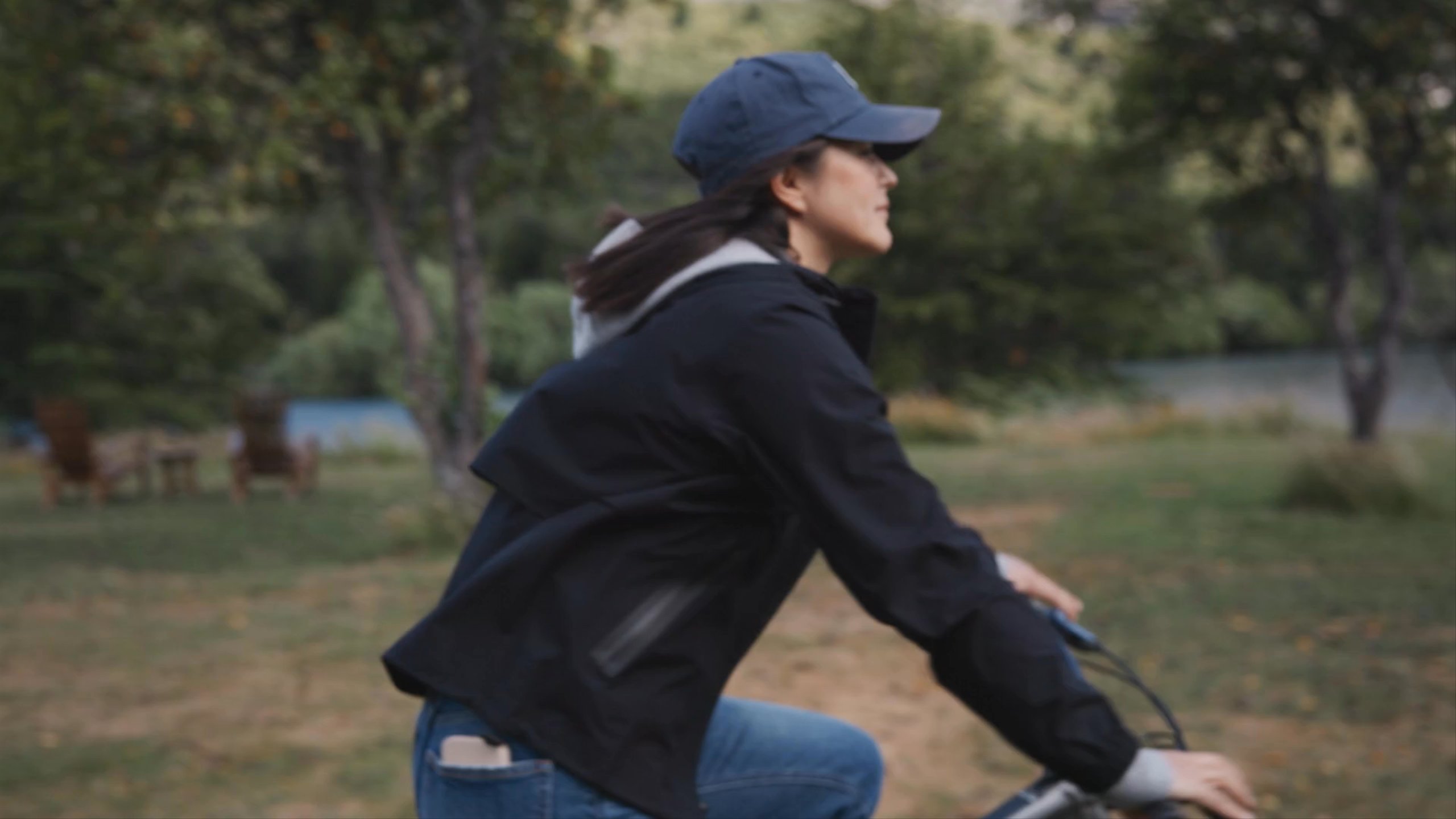 A woman riding bicycle on the field.