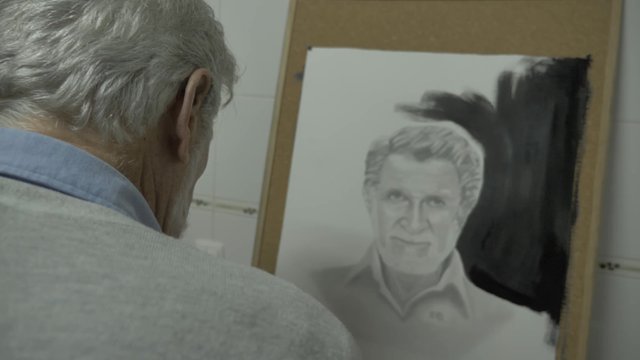 Old man painting a self-portrait