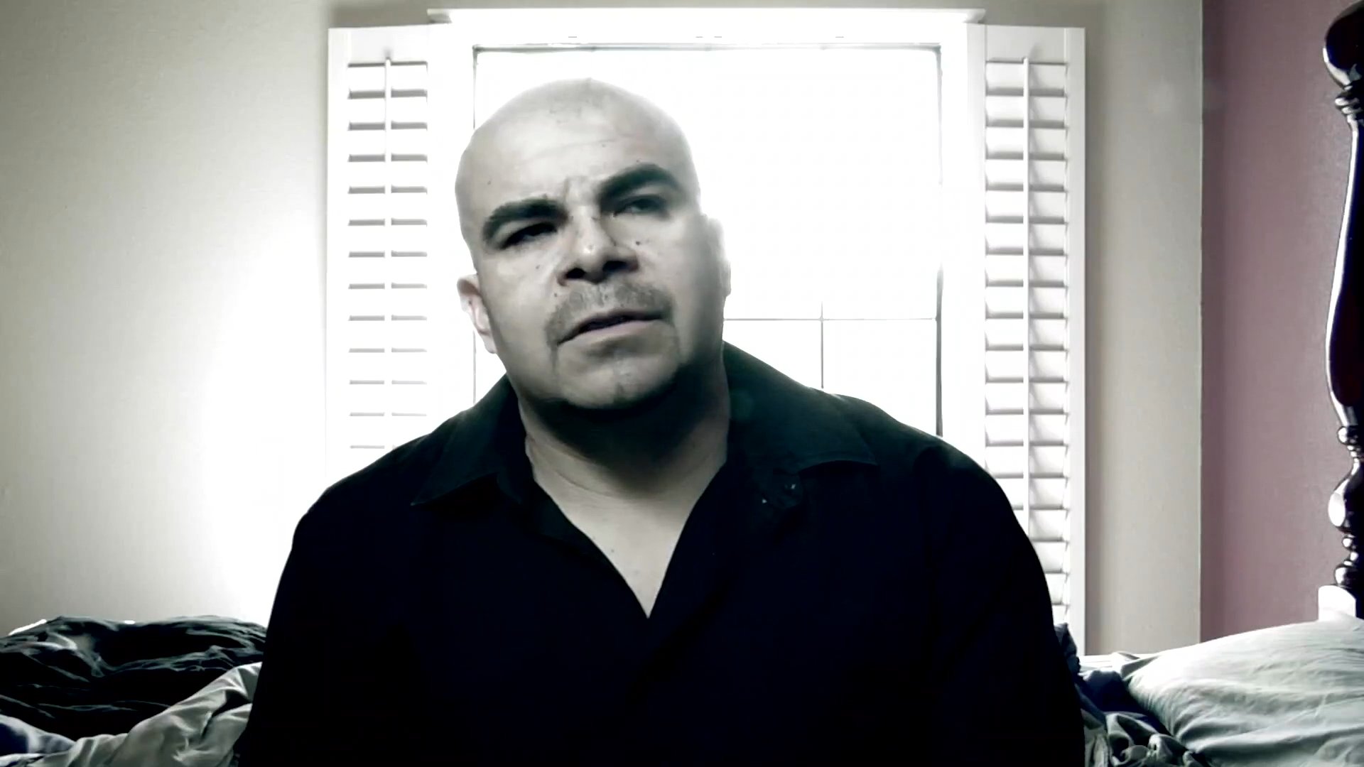 A man shares personal reflections while seated indoors, interspersed with scenes of a quiet backyard environment. The narrative conveys a sense of contemplation and emotional weight.