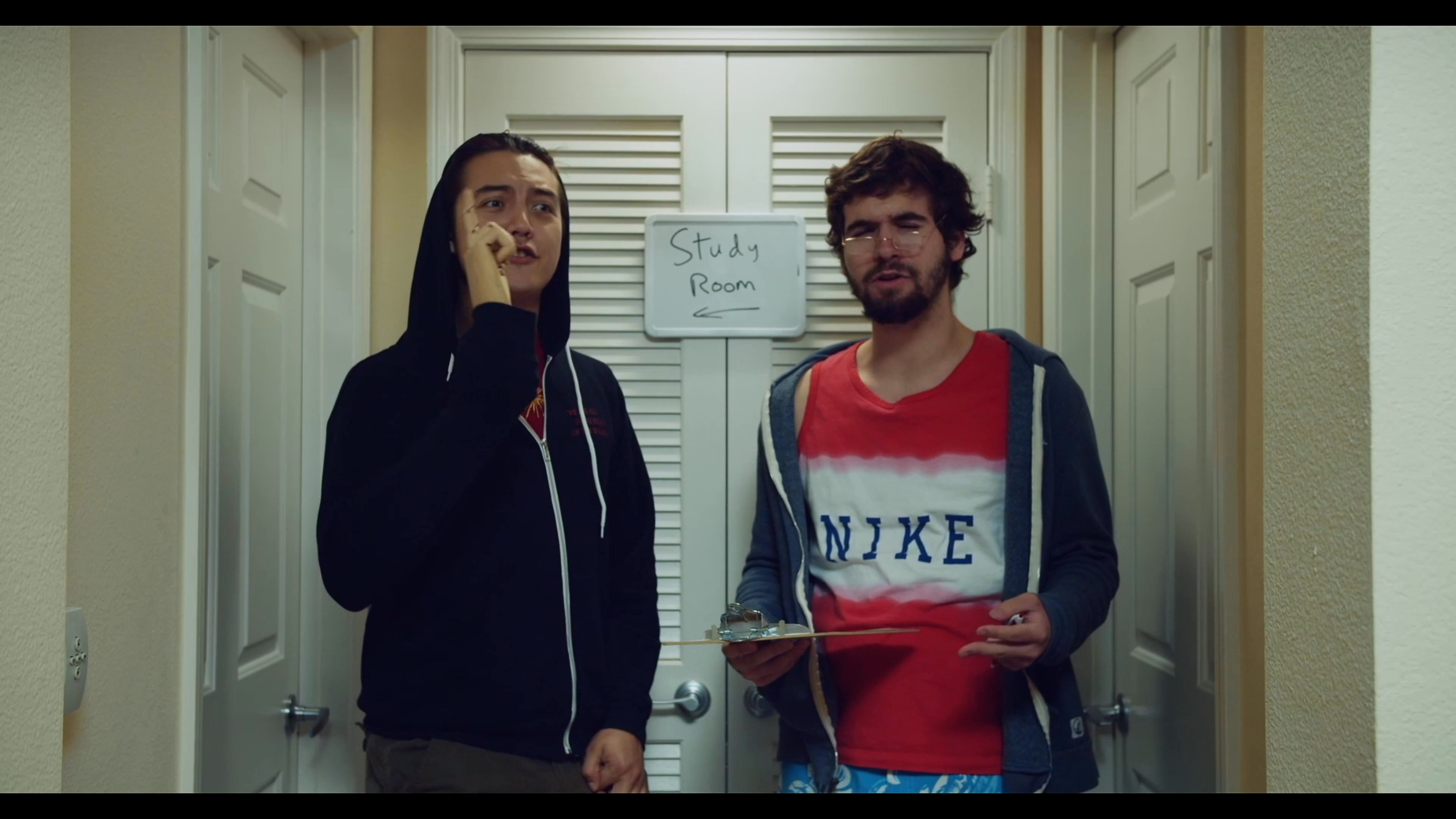Two men engage in a communicative exchange, with one individual using sign language to convey information while the other listens attentively.