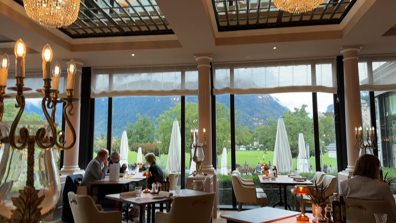 Restaurant La Terrasse - Paraglider lands in view of our table - Hotels & Travel Near Me - Interlaken, BE
