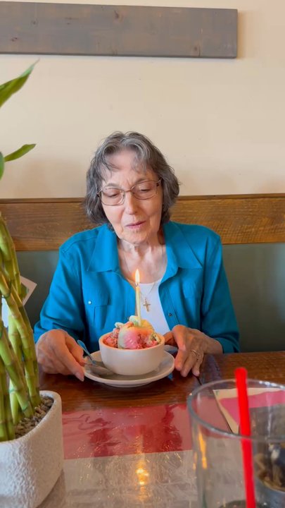 Strings Italian Cafe - Grandma blowing out her candle the staff provided. - Italian Near Me - Carmichael, California