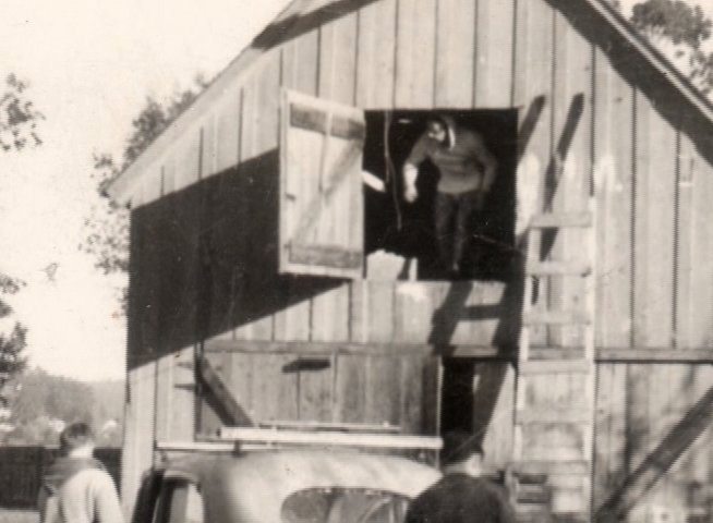 The film features retrospective interviews with individuals reflecting on their experiences, interspersed with archival footage showing surfers carrying and using longboards on the beach.