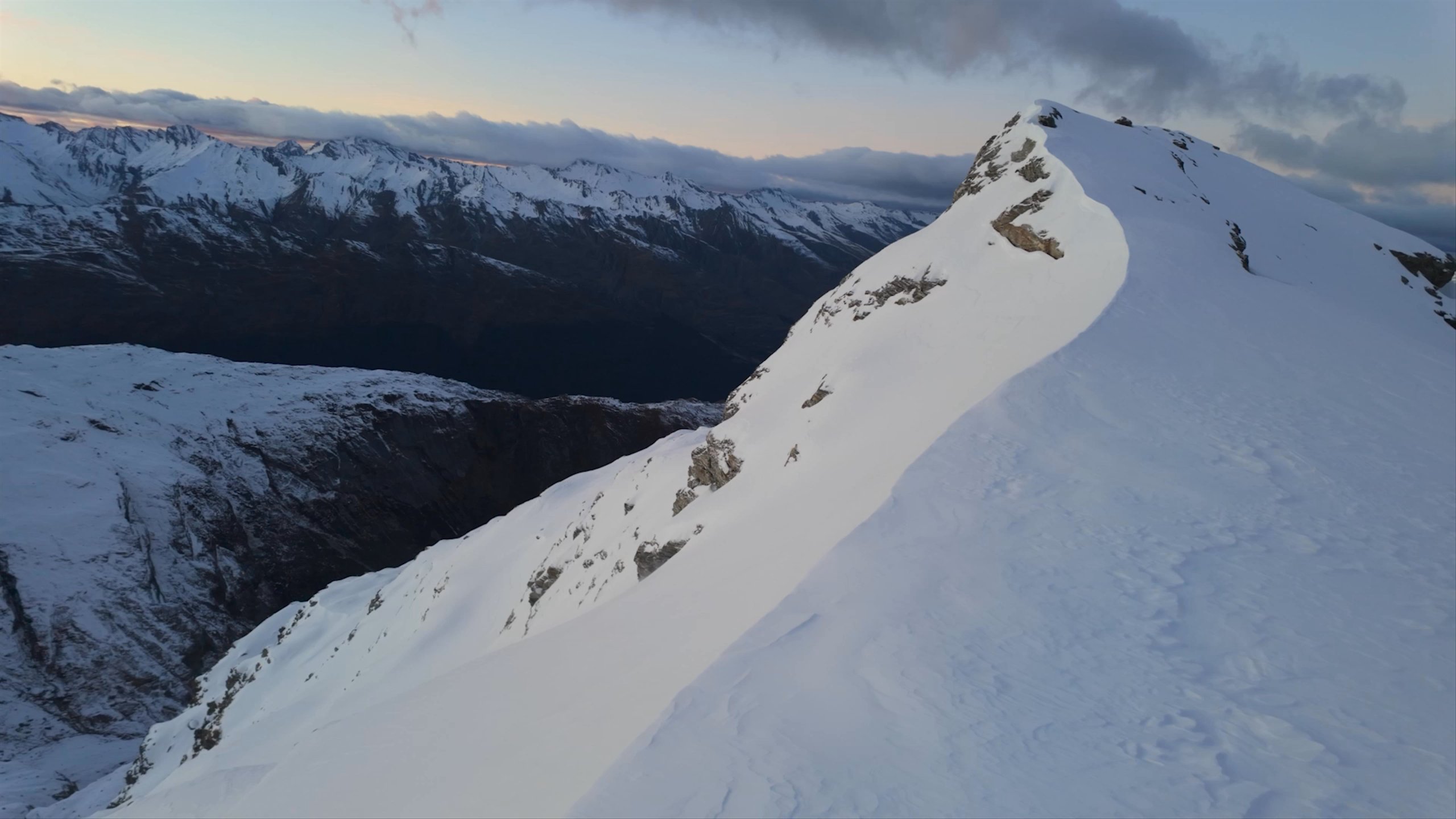 Video montage of man and woman skiing in New Zealand