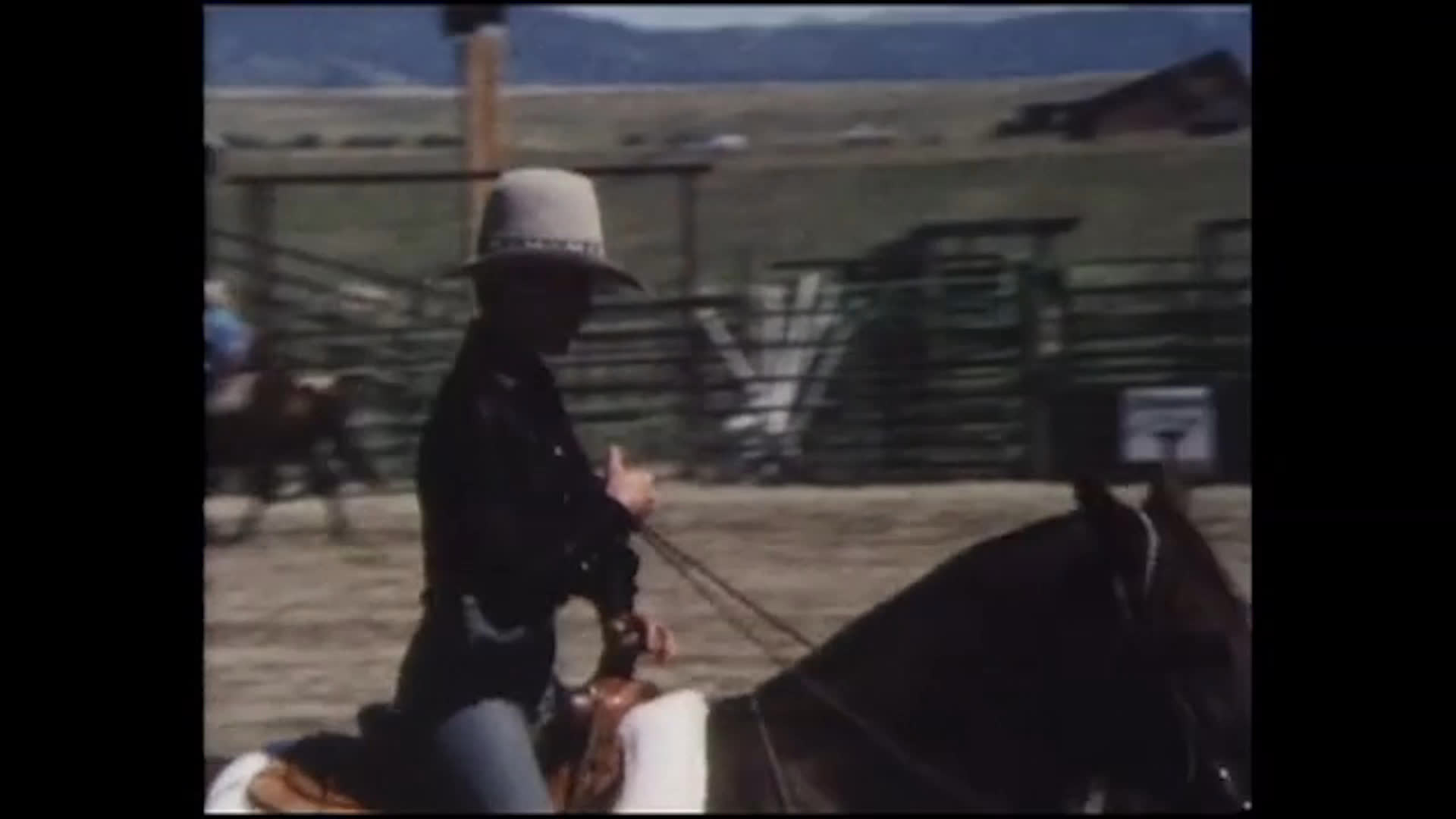 A rider in a cowboy hat rides through a dirt rodeo arena as spectators watch, following a brief bucking-horse sequence. The narration describes rodeo as recreation and a chance to ride a horse also used for ranch work.