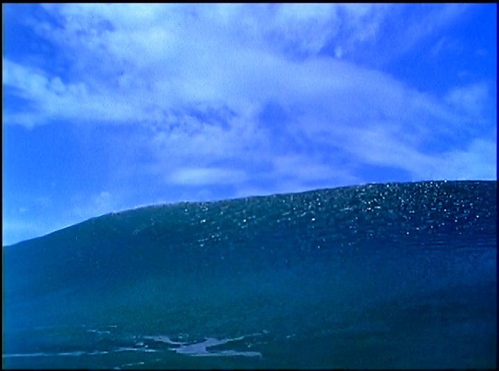 An elderly man shares personal reflections and stories, interspersed with cinematic footage of powerful ocean waves. The narrative highlights his deep connection to the sea.