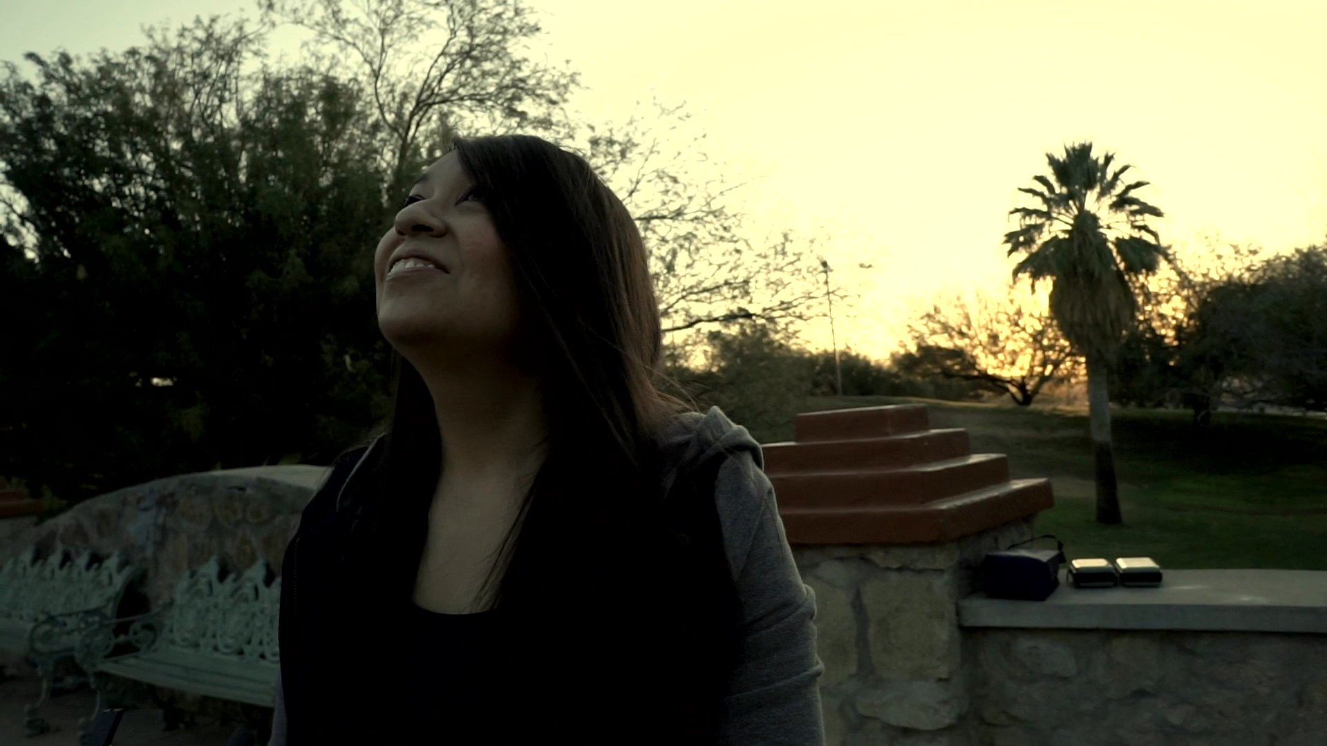 A filmmaker introduces a documentary project focused on mental health awareness developed during the pandemic. The scene features a scenic outdoor location at sunset.