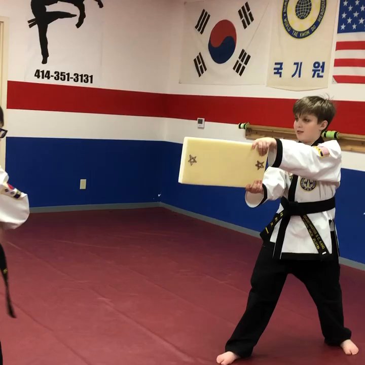 Kang's Tae Kwon Do - Spinning wheel kick practice in Children class - Self-defense Classes Near Me - Fox Point, Wisconsin