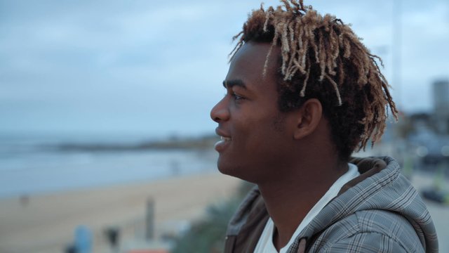 A guy staring into the distance while standing on the dock
