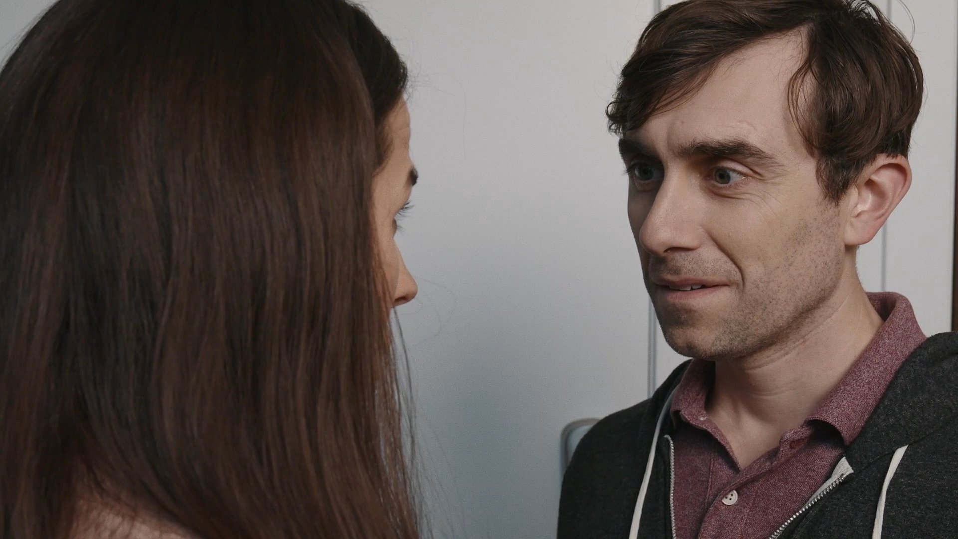 Two individuals engage in a focused, face-to-face dialogue within an office setting, exchanging perspectives through verbal communication and nuanced non-verbal cues.