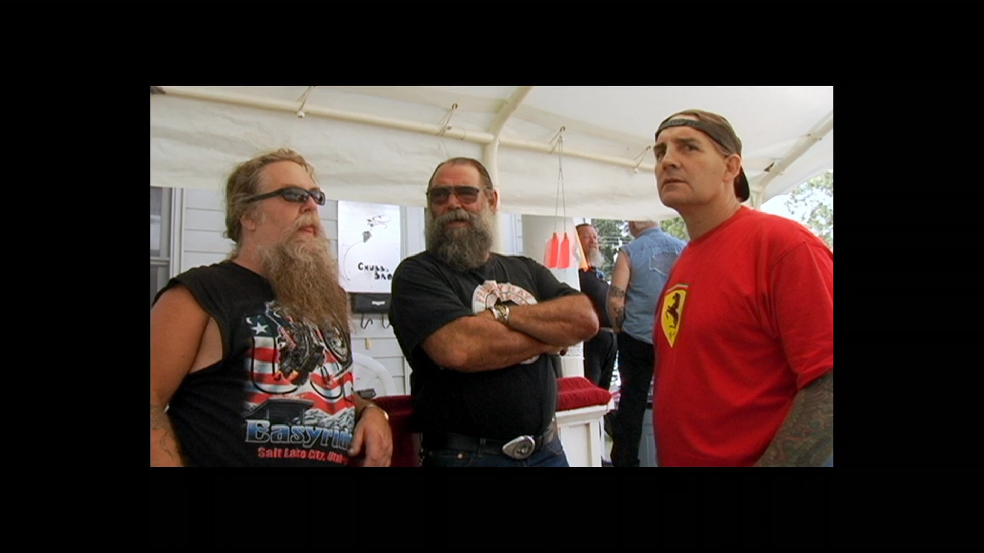 This sequence profiles various motorcycle clubs, featuring members at a gathering and riding on open roads. The footage emphasizes group identity and brotherhood within the biker community.