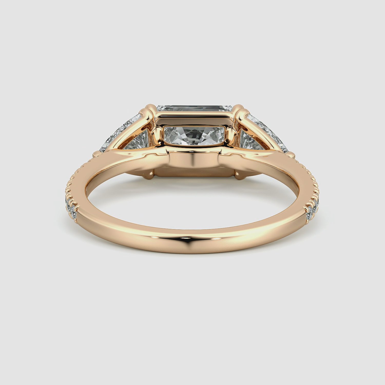 The Three Stone | Radiant | 14k | Rose Gold | bandAccent: Pavé | diamondOrientation: horizontal | sideStoneCarat: 0.50ct | sideStoneShape: Trillion | caratWeight: other
