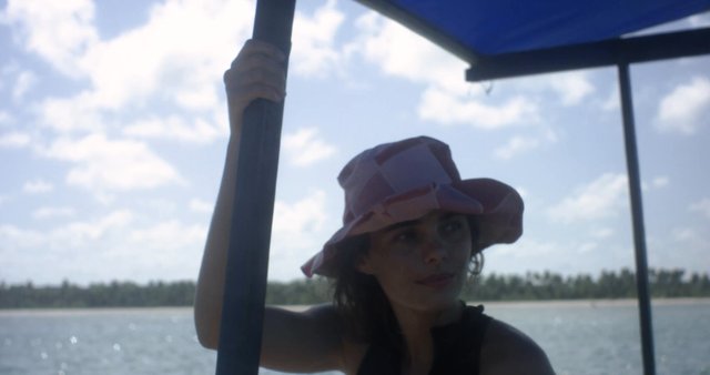 Girl wearing a hat on a boat