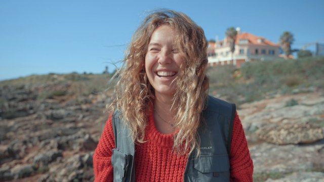 A joyful girl smiling on the coast