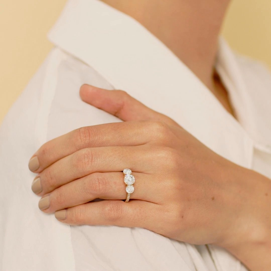 The Three Stone | Round Brilliant | Platinum | bandAccent: Pavé | caratWeight: other | sideStoneCarat: 0.50ct | sideStoneShape: Round Brilliant | diamondOrientation: vertical