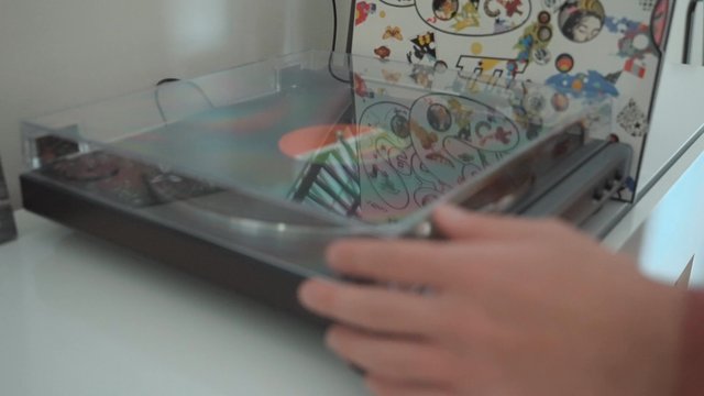A guy opening a turntable