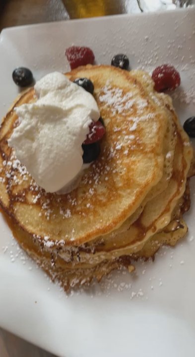 The Edge Harlem - Syrup pour on the rum-spiced whipped cream and berry pancakes - Caribbean Near Me - New York, New York