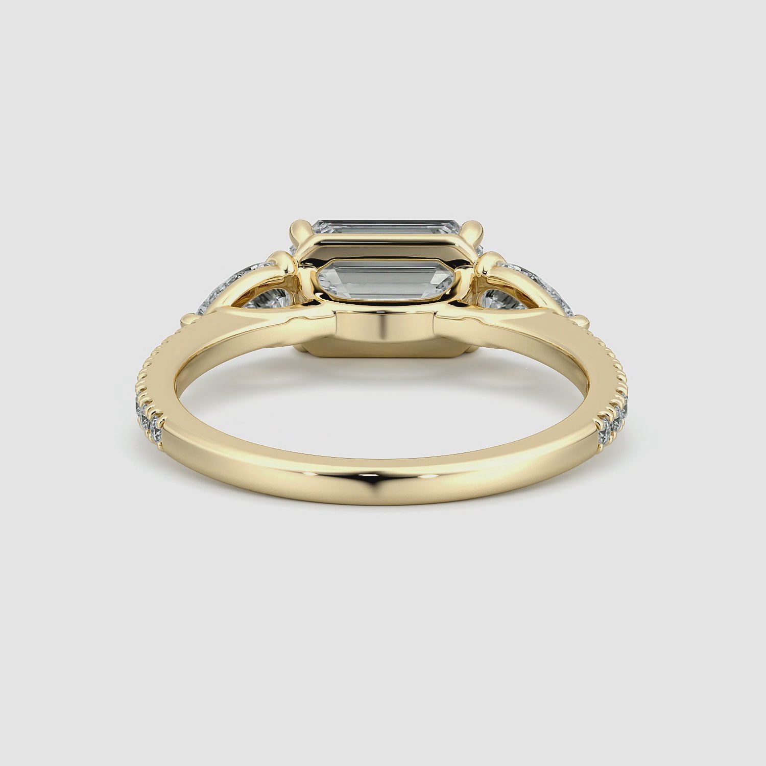 The Three Stone | Emerald | 18k | Yellow Gold | bandAccent: Pavé | diamondOrientation: horizontal | sideStoneCarat: 0.25ct | sideStoneShape: Pear | caratWeight: other
